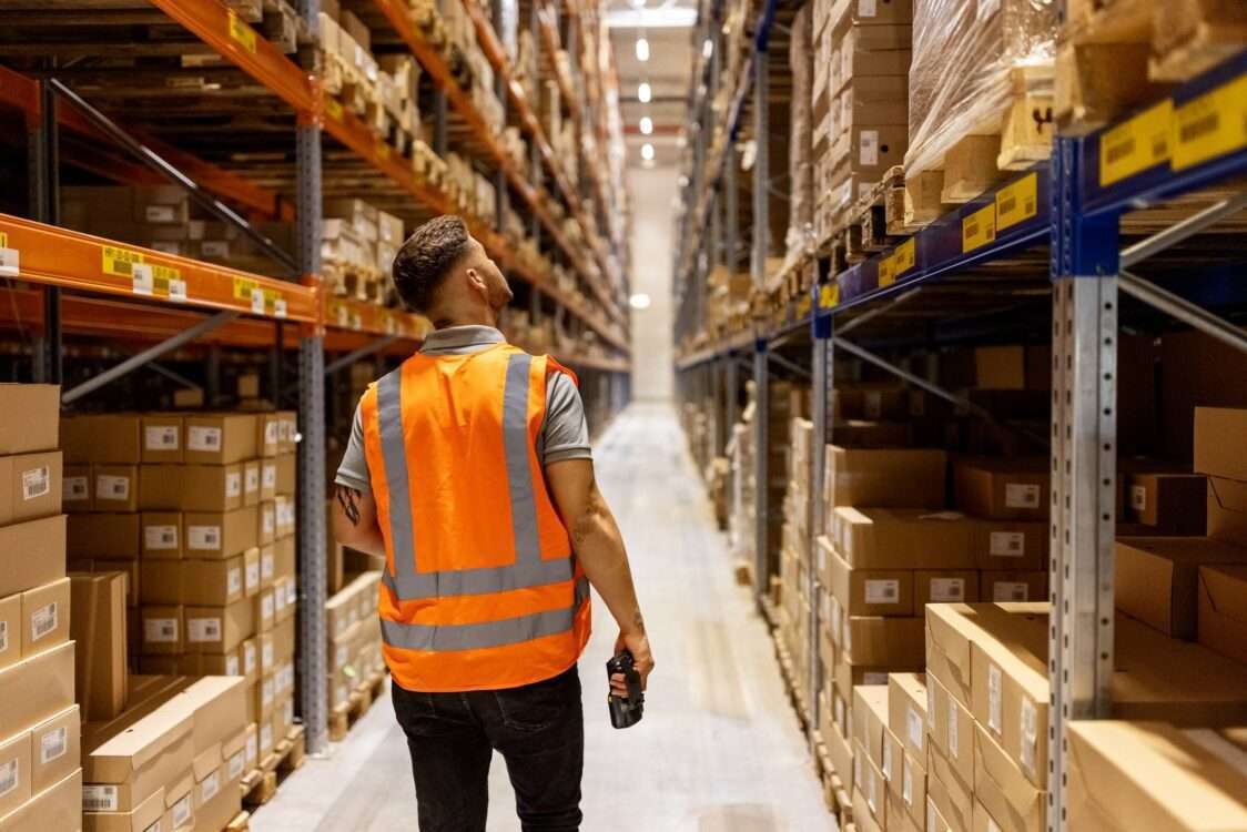 Worker in reflective clothing working in the warehouse